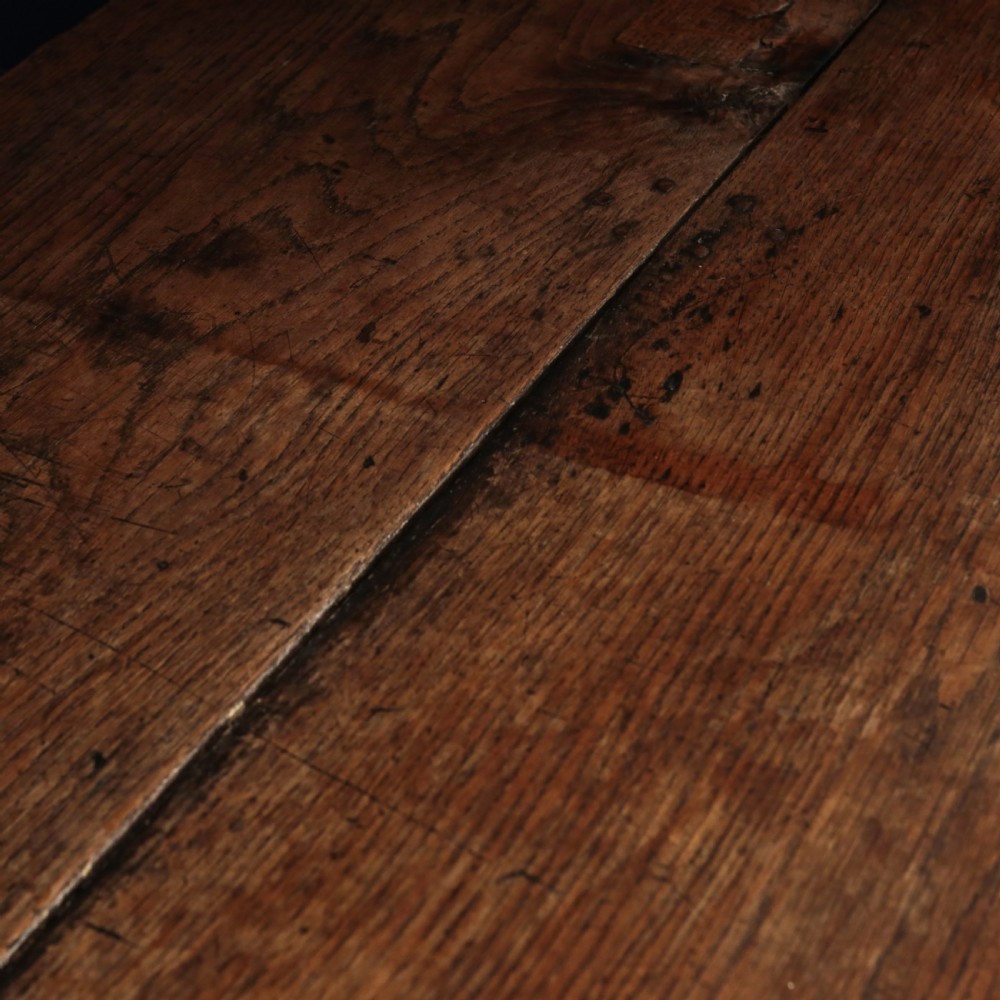 A long 17th-century oak refectory table featuring turned baluster legs, low stretchers, and a thick plank top. View VIII