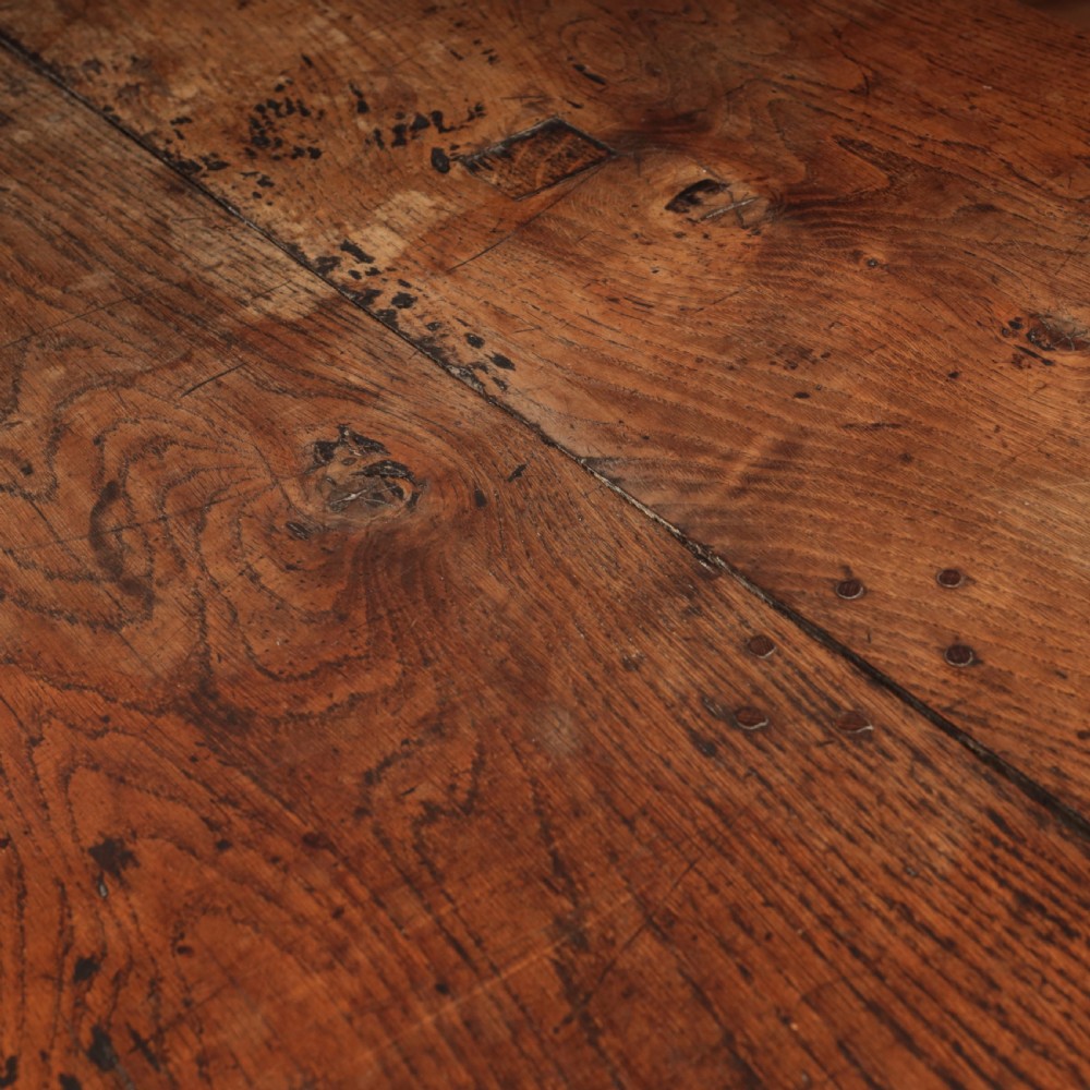 A long 17th-century oak refectory table featuring turned baluster legs, low stretchers, and a thick plank top. View XII