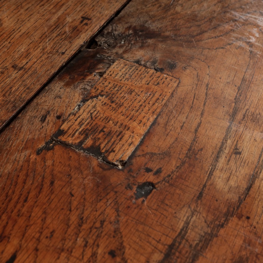 A long 17th-century oak refectory table featuring turned baluster legs, low stretchers, and a thick plank top. View XIII
