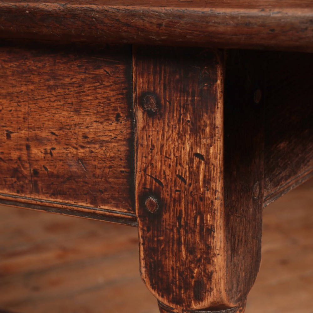 A long 17th-century oak refectory table featuring turned baluster legs, low stretchers, and a thick plank top. View XVII