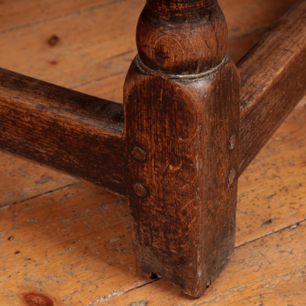 A long 17th-century oak refectory table featuring turned baluster legs, low stretchers, and a thick plank top. View XVIII