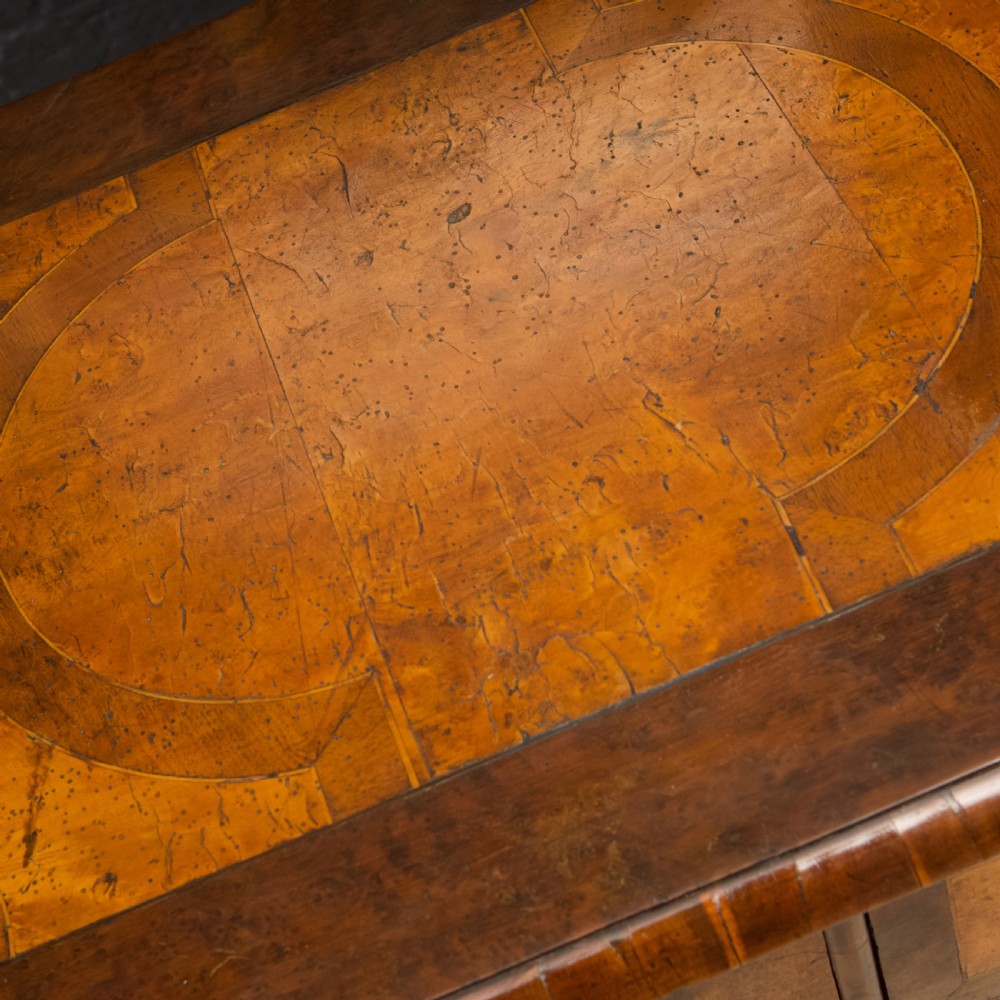 A late 17th-century William and Mary chest of drawers crafted from yew and maple featuring geometric inlaid panels, teardrop brass handles, and turned bun feet. View XIV