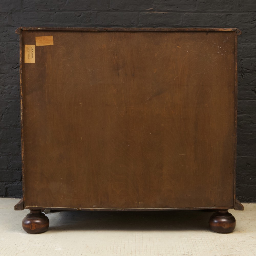 A late 17th-century William and Mary chest of drawers crafted from yew and maple featuring geometric inlaid panels, teardrop brass handles, and turned bun feet. View XVI