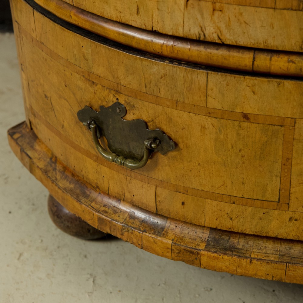 An 18th-century South German walnut chest of drawers featuring a serpentine front, four crossbanded drawers, brass drop handles, and turned bun feet. View XIII
