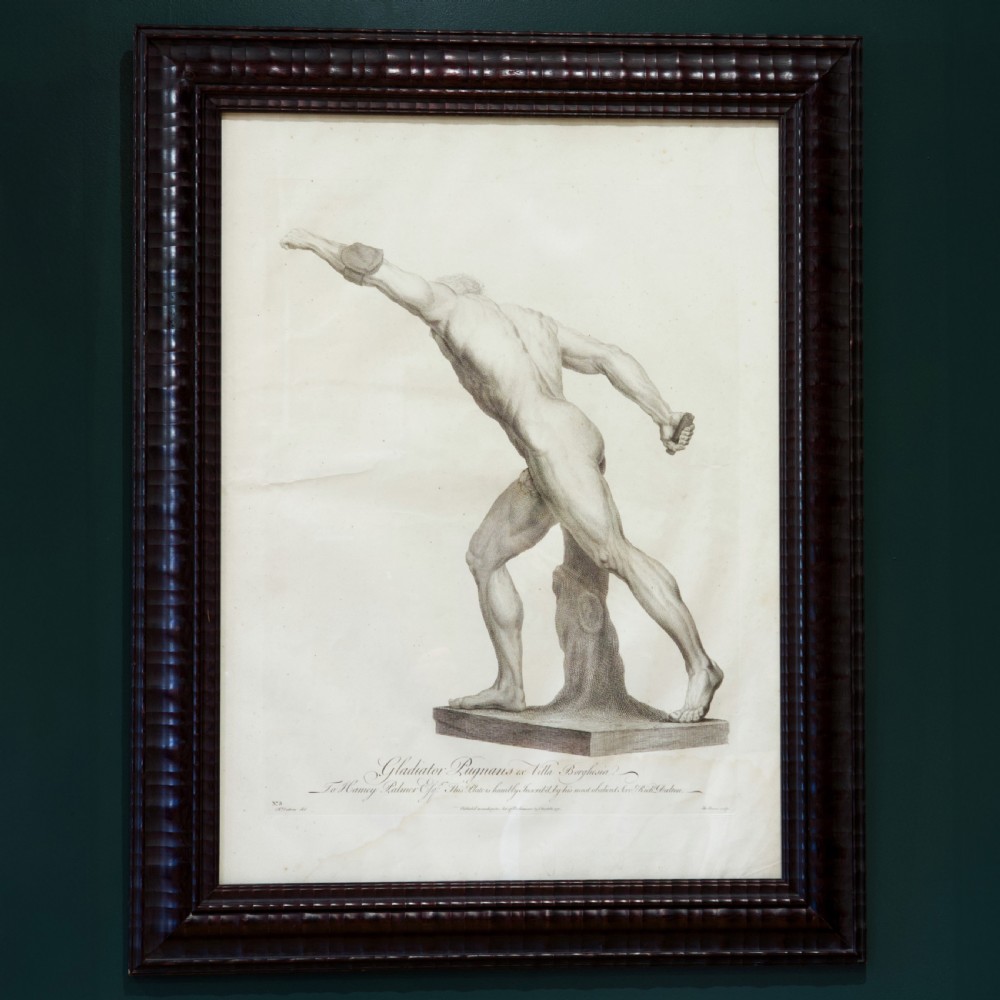 A set of six dark-framed monochrome antique engravings depicting classical statues arranged in two rows. View II