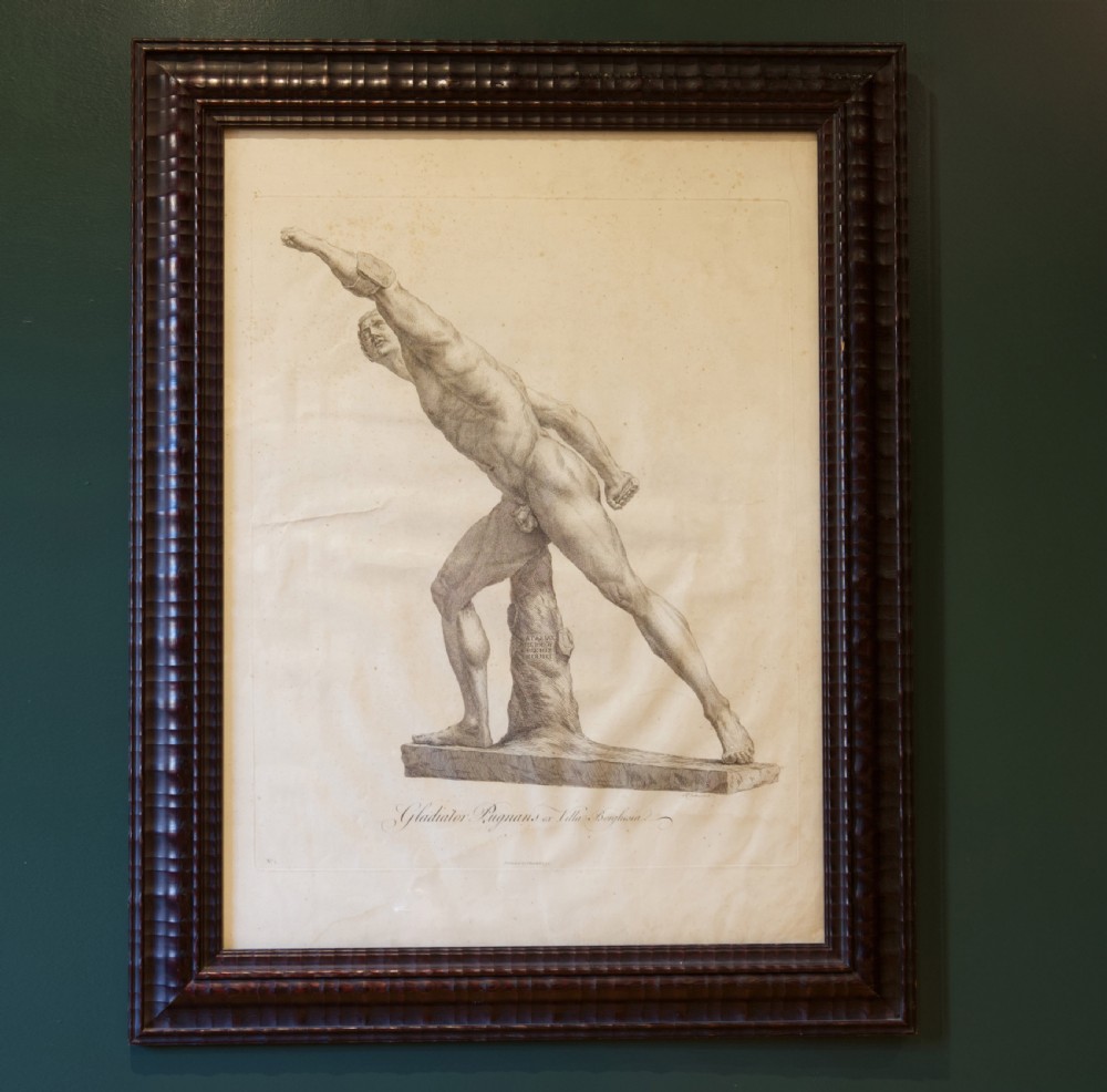 A set of six dark-framed monochrome antique engravings depicting classical statues arranged in two rows. View V