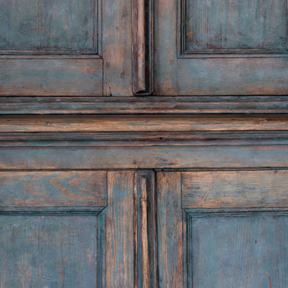 An eighteenth-century French buffet a deux corps with a distressed blue painted finish, arched upper cabinet doors, and iron hardware. View IX