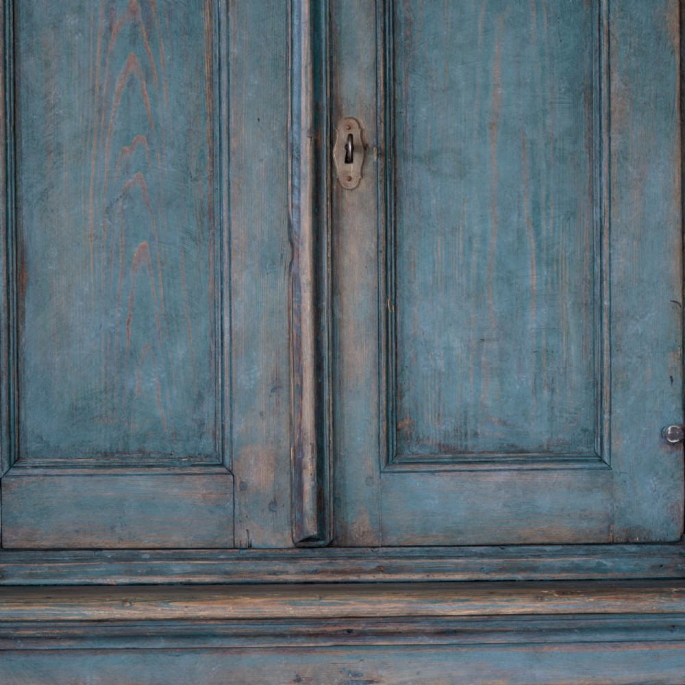 An eighteenth-century French buffet a deux corps with a distressed blue painted finish, arched upper cabinet doors, and iron hardware. View XII