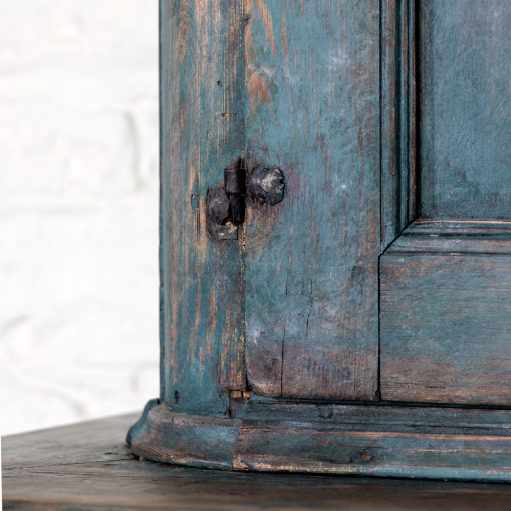 An eighteenth-century French buffet a deux corps with a distressed blue painted finish, arched upper cabinet doors, and iron hardware. View XVIII