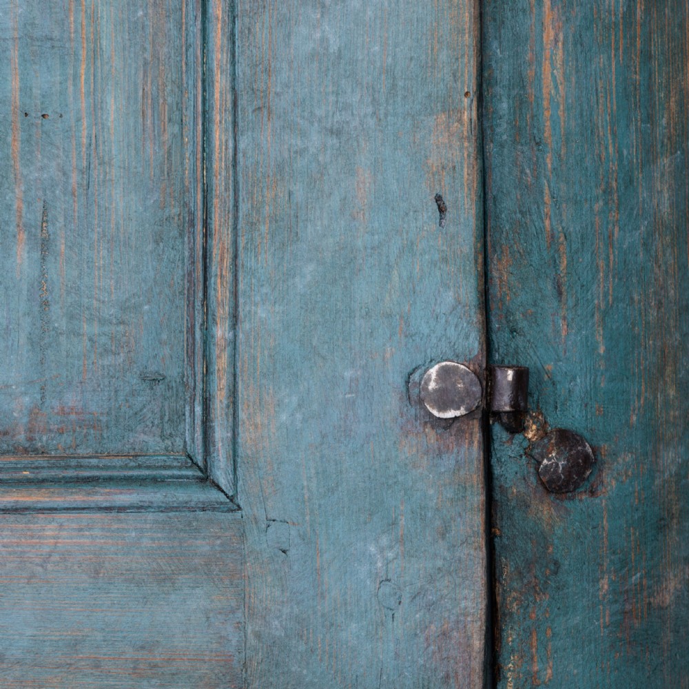 An eighteenth-century French buffet a deux corps with a distressed blue painted finish, arched upper cabinet doors, and iron hardware. View XIX