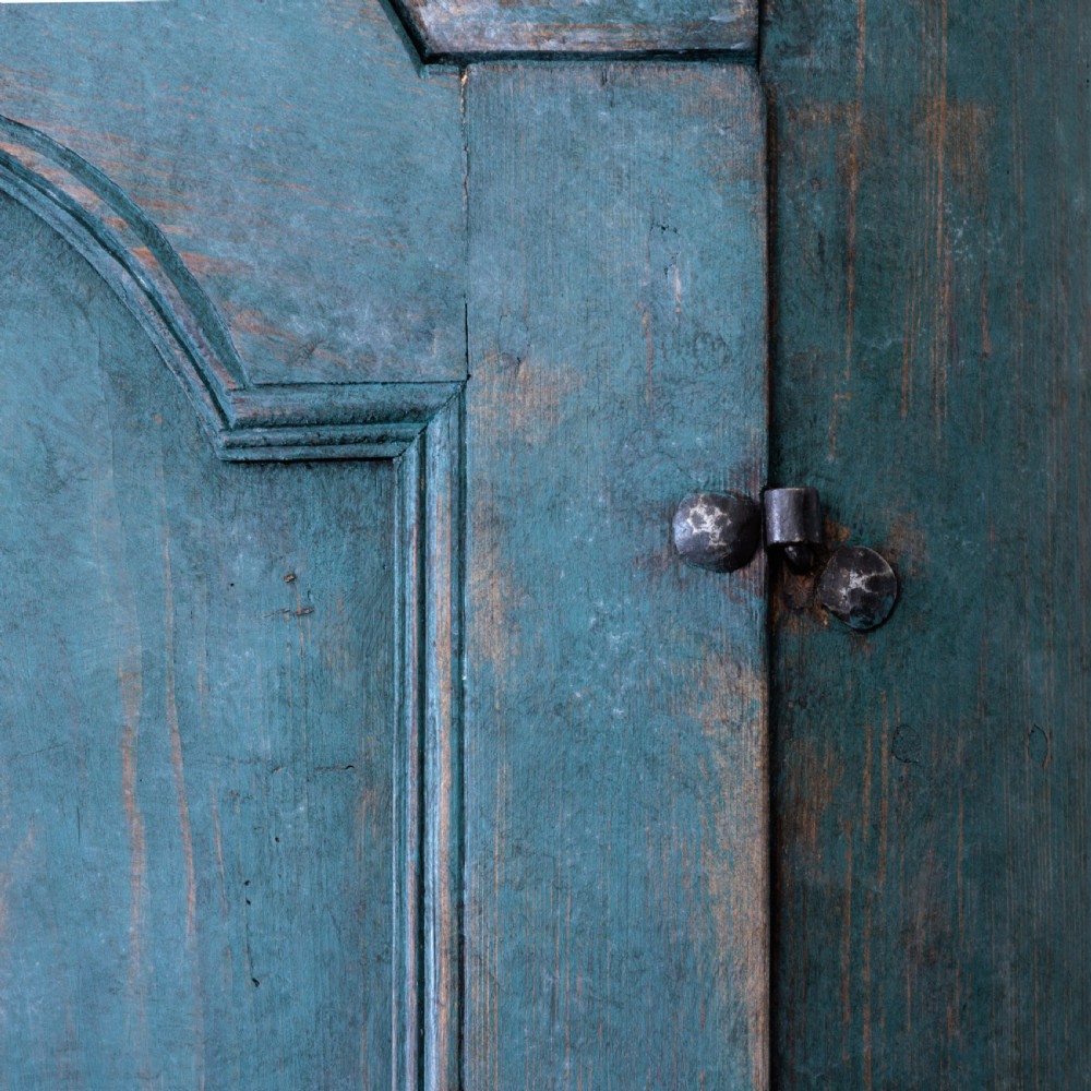 An eighteenth-century French buffet a deux corps with a distressed blue painted finish, arched upper cabinet doors, and iron hardware. View XXI