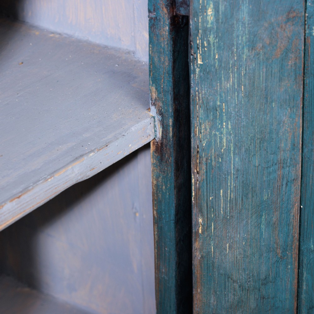 An eighteenth-century French buffet a deux corps with a distressed blue painted finish, arched upper cabinet doors, and iron hardware. View XXX