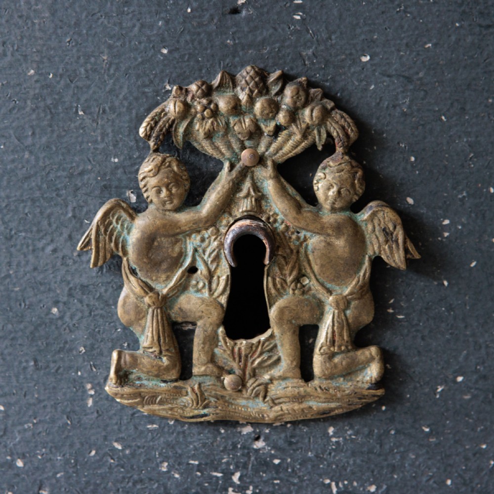 An 18th-century dark green painted serpentine-front chest featuring three drawers and detailed brass keyhole escutcheons. View VI