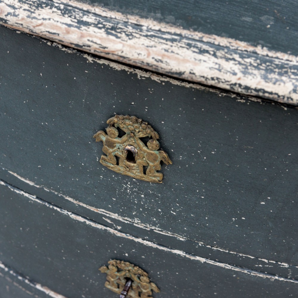 An 18th-century dark green painted serpentine-front chest featuring three drawers and detailed brass keyhole escutcheons. View VIII