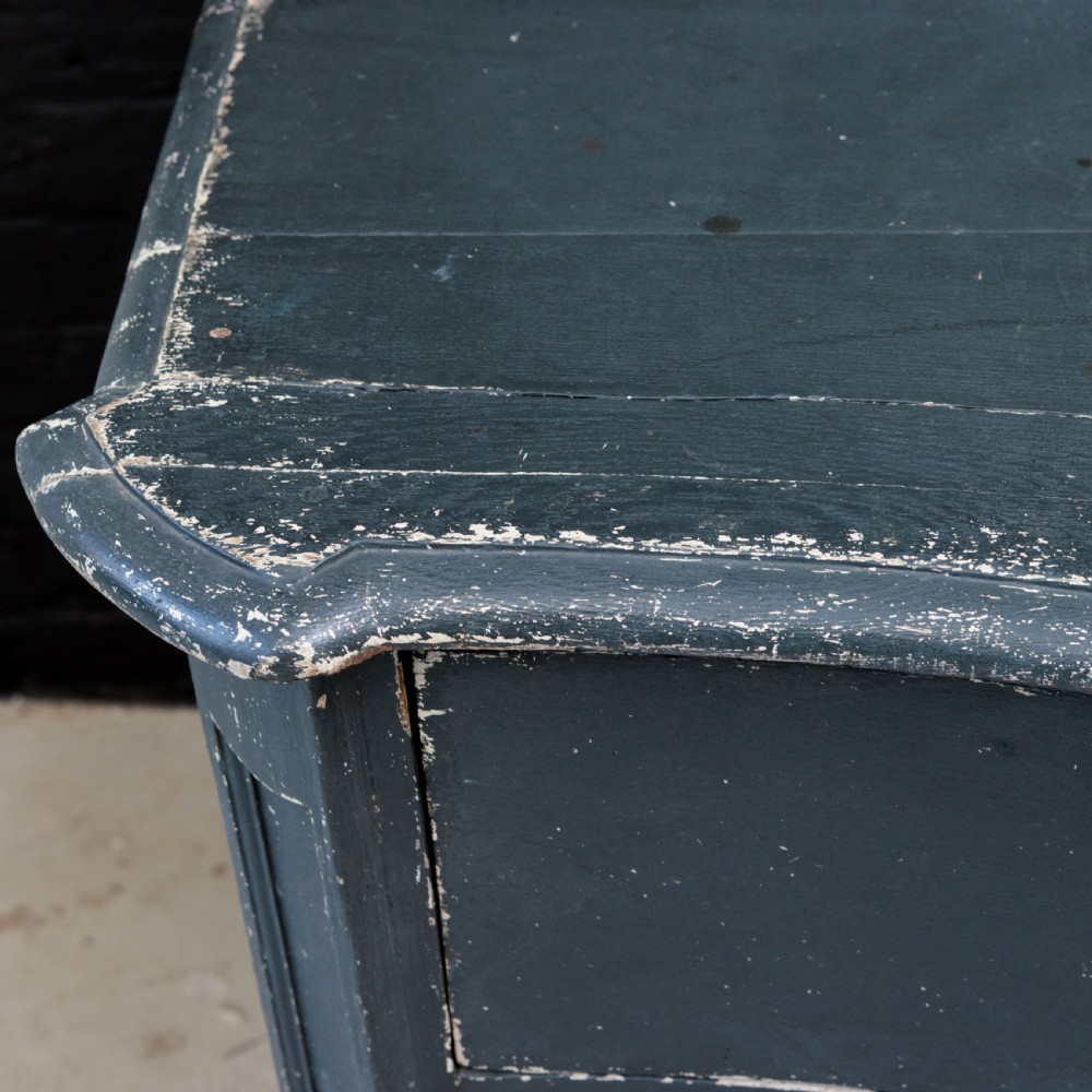An 18th-century dark green painted serpentine-front chest featuring three drawers and detailed brass keyhole escutcheons. View IX