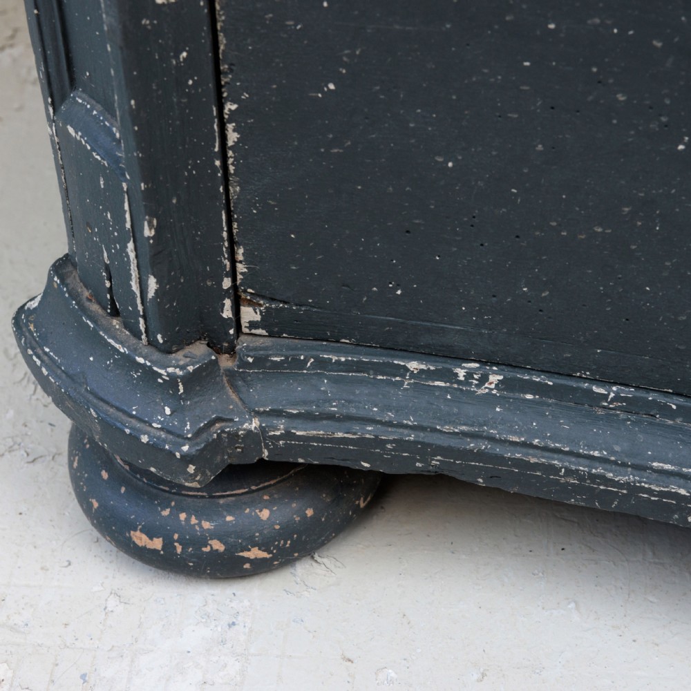 An 18th-century dark green painted serpentine-front chest featuring three drawers and detailed brass keyhole escutcheons. View X