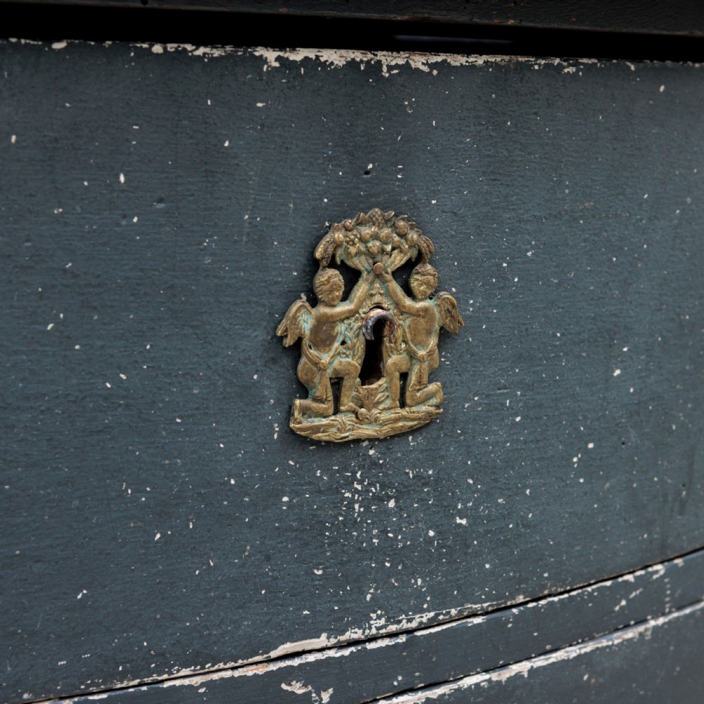 An 18th-century dark green painted serpentine-front chest featuring three drawers and detailed brass keyhole escutcheons. View XI