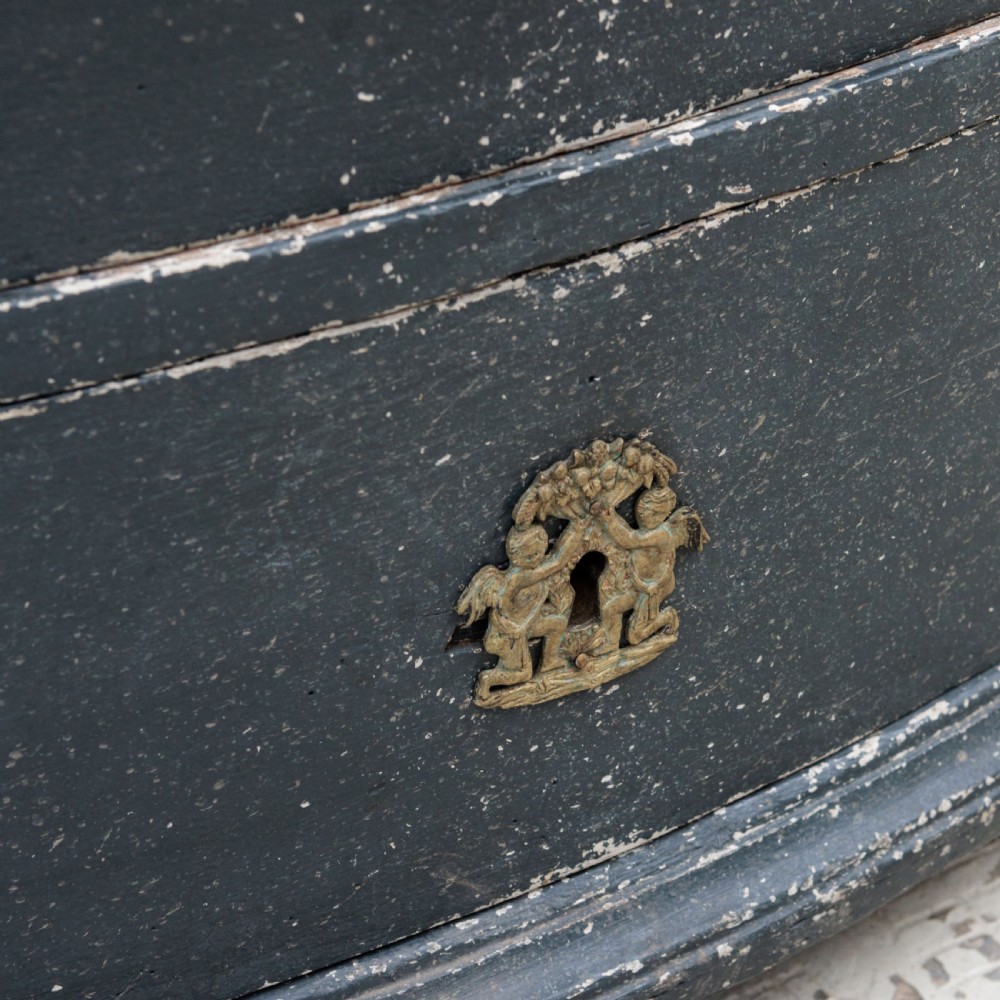 An 18th-century dark green painted serpentine-front chest featuring three drawers and detailed brass keyhole escutcheons. View XIII