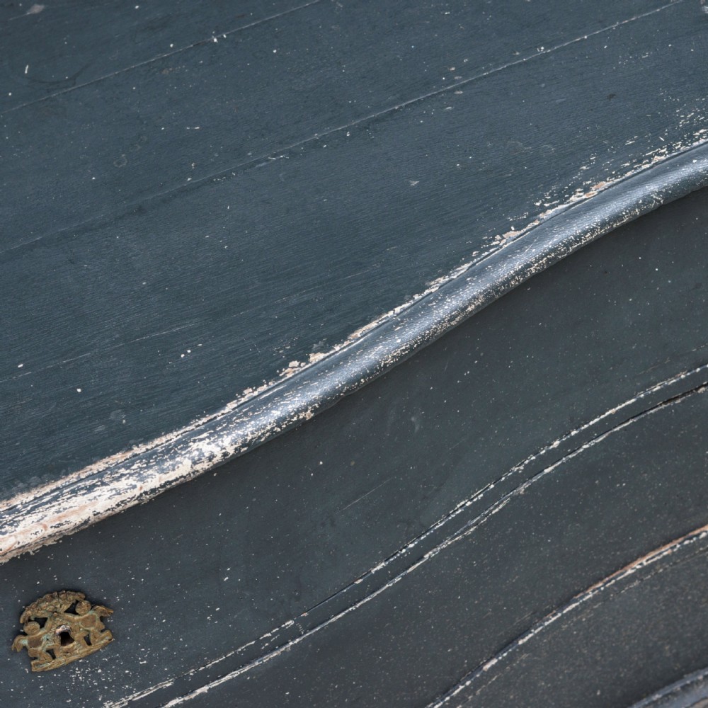 An 18th-century dark green painted serpentine-front chest featuring three drawers and detailed brass keyhole escutcheons. View XIV
