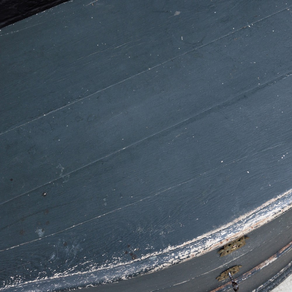 An 18th-century dark green painted serpentine-front chest featuring three drawers and detailed brass keyhole escutcheons. View XXII