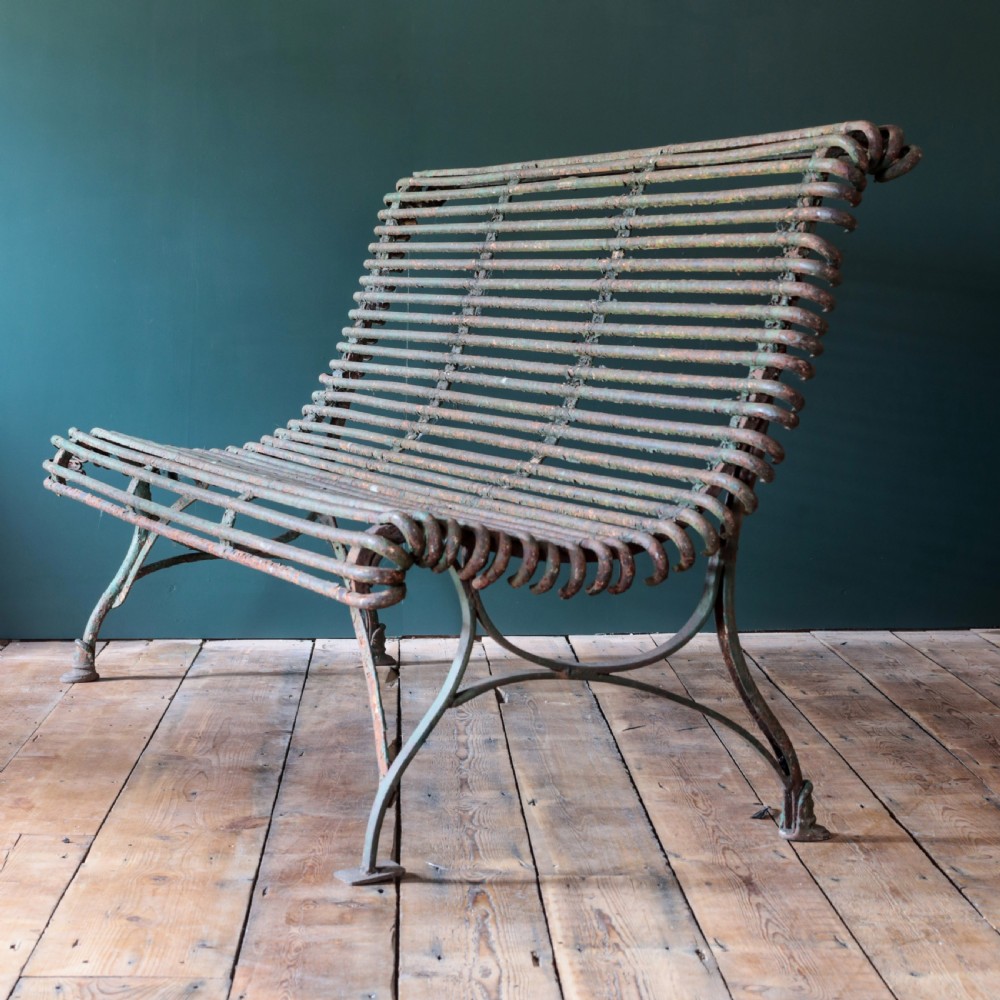 A nineteenth-century French Arras garden bench made of curved green tubular iron slats resting on a riveted iron frame. View II