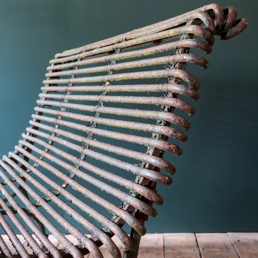 A nineteenth-century French Arras garden bench made of curved green tubular iron slats resting on a riveted iron frame. View IV
