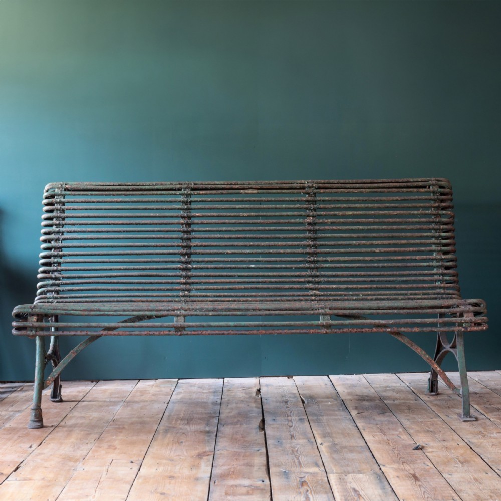 A nineteenth-century French Arras garden bench made of curved green tubular iron slats resting on a riveted iron frame. View V