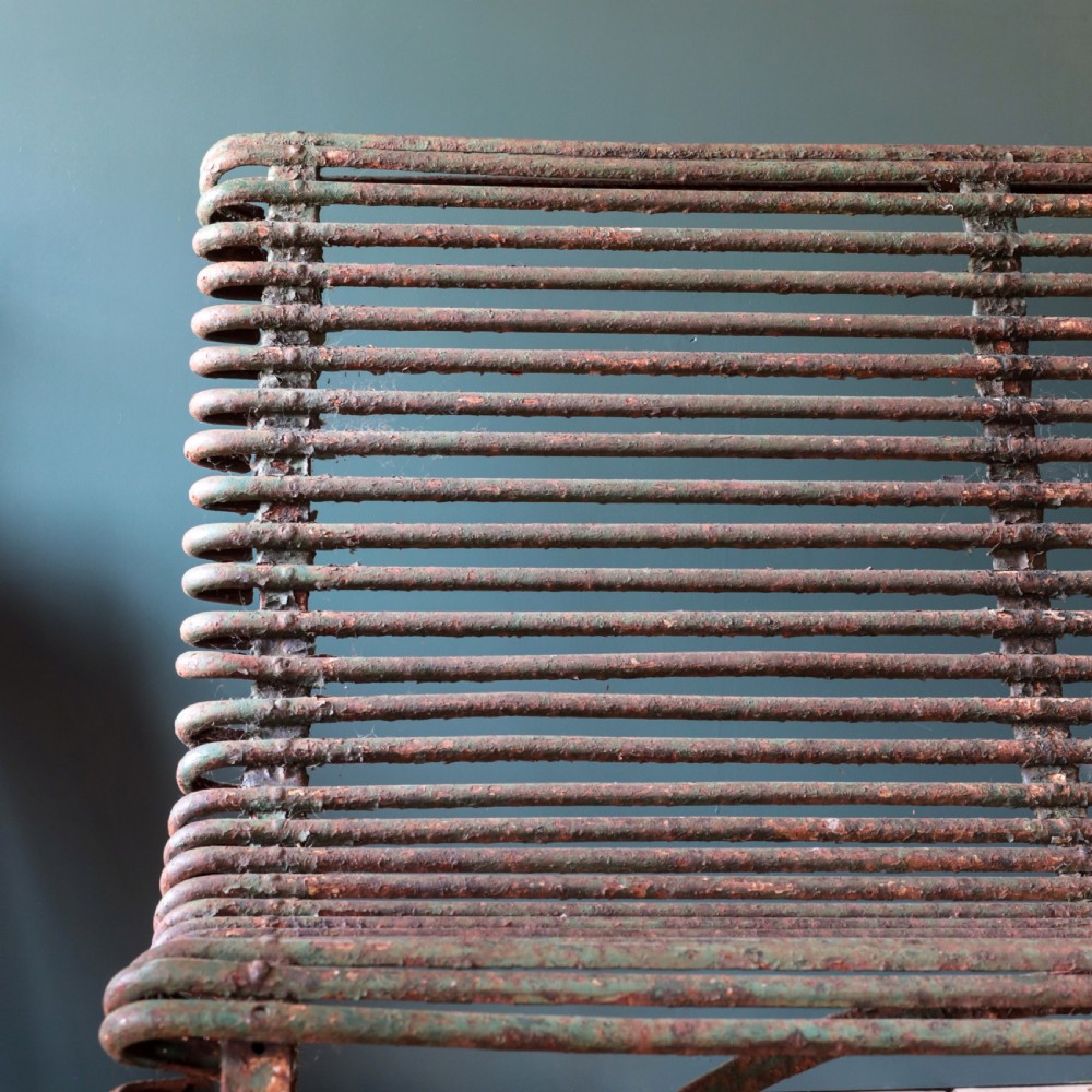 A nineteenth-century French Arras garden bench made of curved green tubular iron slats resting on a riveted iron frame. View VI