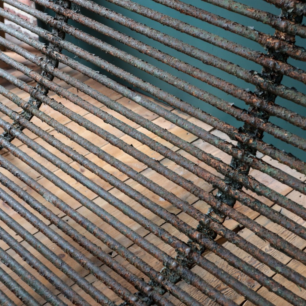 A nineteenth-century French Arras garden bench made of curved green tubular iron slats resting on a riveted iron frame. View VIII