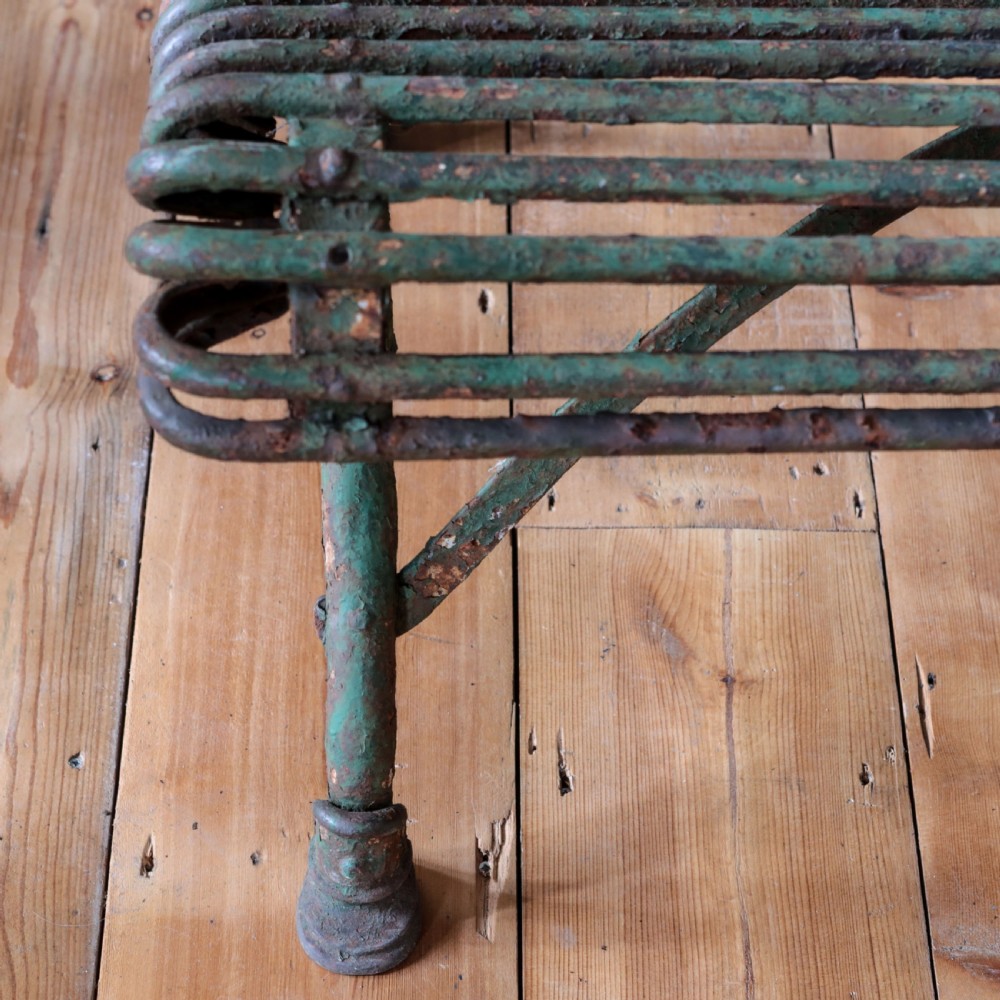A nineteenth-century French Arras garden bench made of curved green tubular iron slats resting on a riveted iron frame. View IX