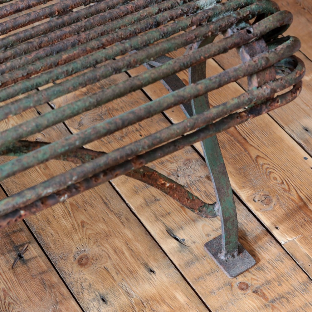 A nineteenth-century French Arras garden bench made of curved green tubular iron slats resting on a riveted iron frame. View X