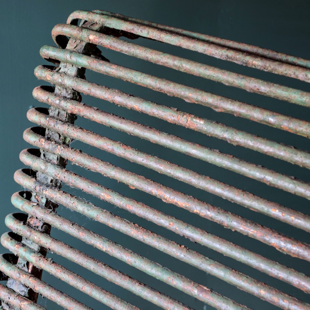 A nineteenth-century French Arras garden bench made of curved green tubular iron slats resting on a riveted iron frame. View XI