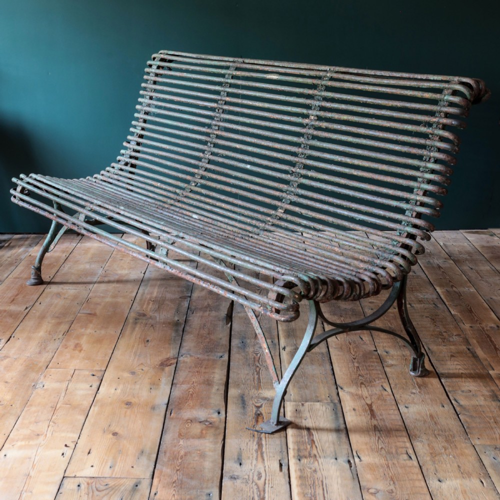A nineteenth-century French Arras garden bench made of curved green tubular iron slats resting on a riveted iron frame. View XIII