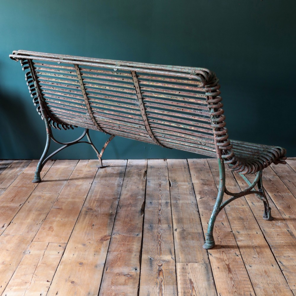 A nineteenth-century French Arras garden bench made of curved green tubular iron slats resting on a riveted iron frame. View XIV