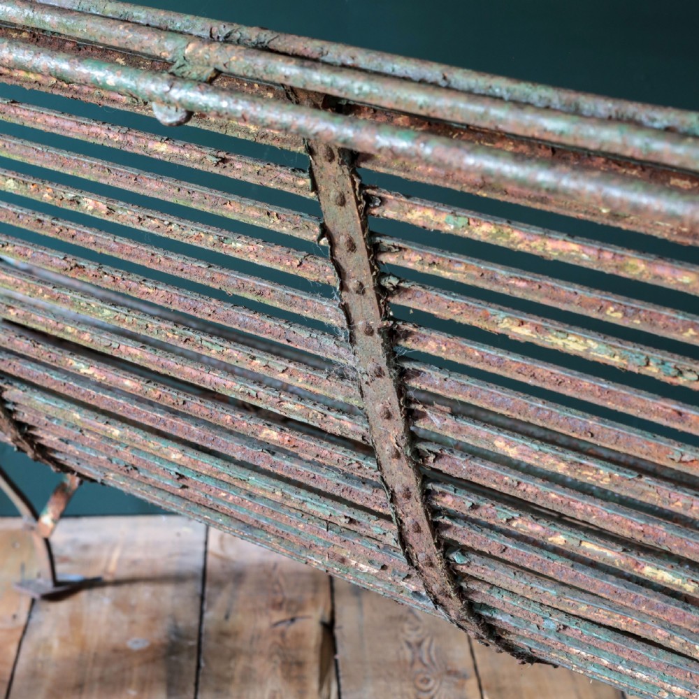 A nineteenth-century French Arras garden bench made of curved green tubular iron slats resting on a riveted iron frame. View XV
