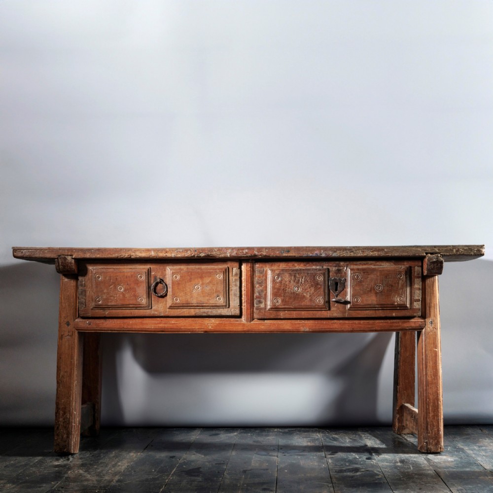 An 18th-century Spanish wooden console table featuring two carved drawer fronts with iron handles and a thick timber top. View II