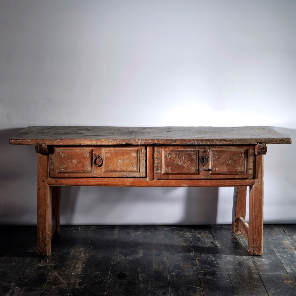 An 18th-century Spanish wooden console table featuring two carved drawer fronts with iron handles and a thick timber top. View III