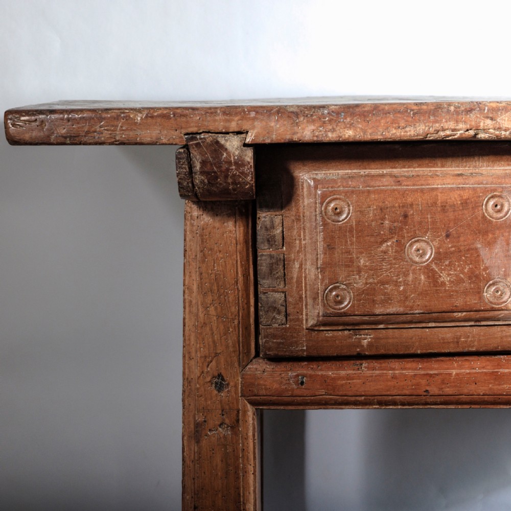 An 18th-century Spanish wooden console table featuring two carved drawer fronts with iron handles and a thick timber top. View VI