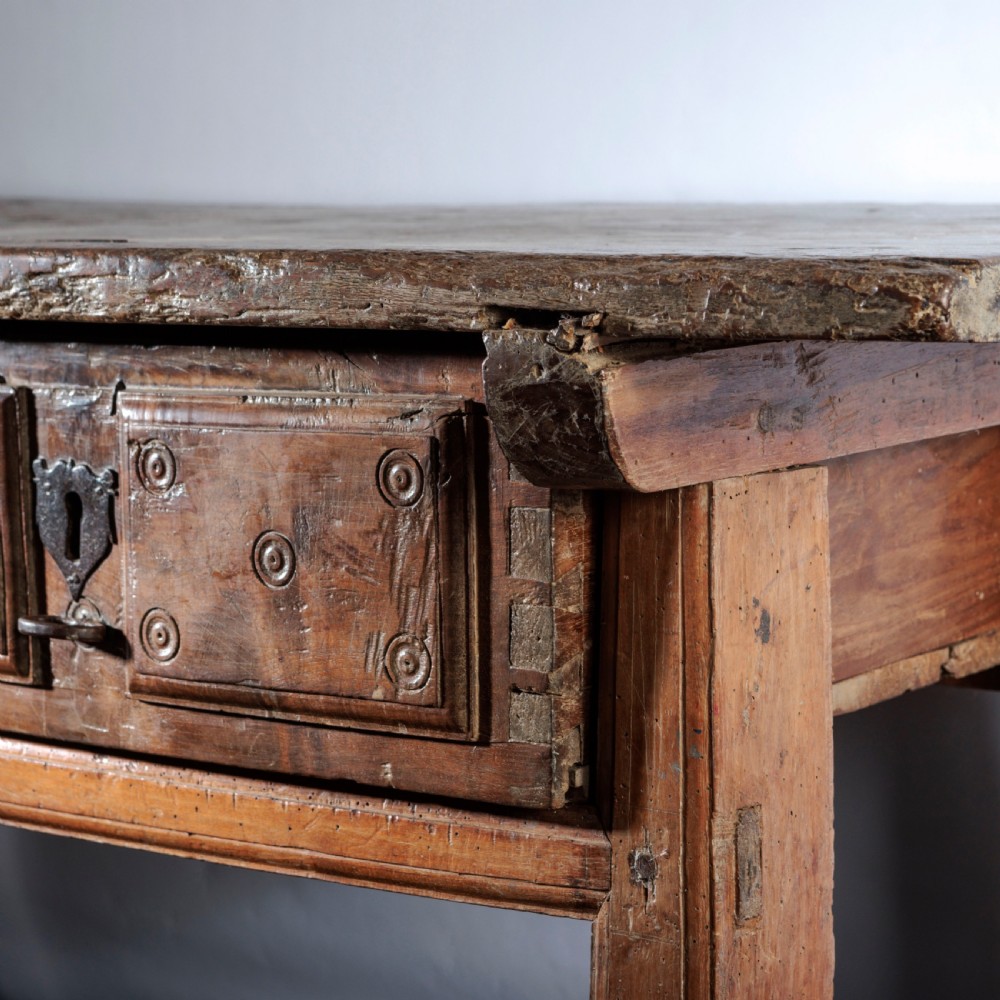 An 18th-century Spanish wooden console table featuring two carved drawer fronts with iron handles and a thick timber top. View VIII