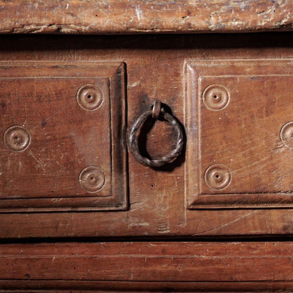 An 18th-century Spanish wooden console table featuring two carved drawer fronts with iron handles and a thick timber top. View X