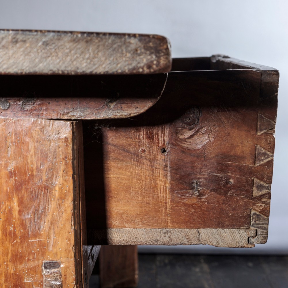 An 18th-century Spanish wooden console table featuring two carved drawer fronts with iron handles and a thick timber top. View XVII