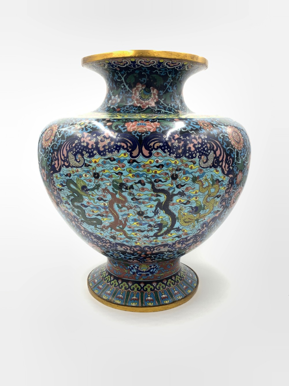 A bulbous 19th-century Chinese cloisonne enamel vase with a flared neck, featuring circular yellow dragon medallions surrounded by dense floral scrollwork on a dark blue ground. View II