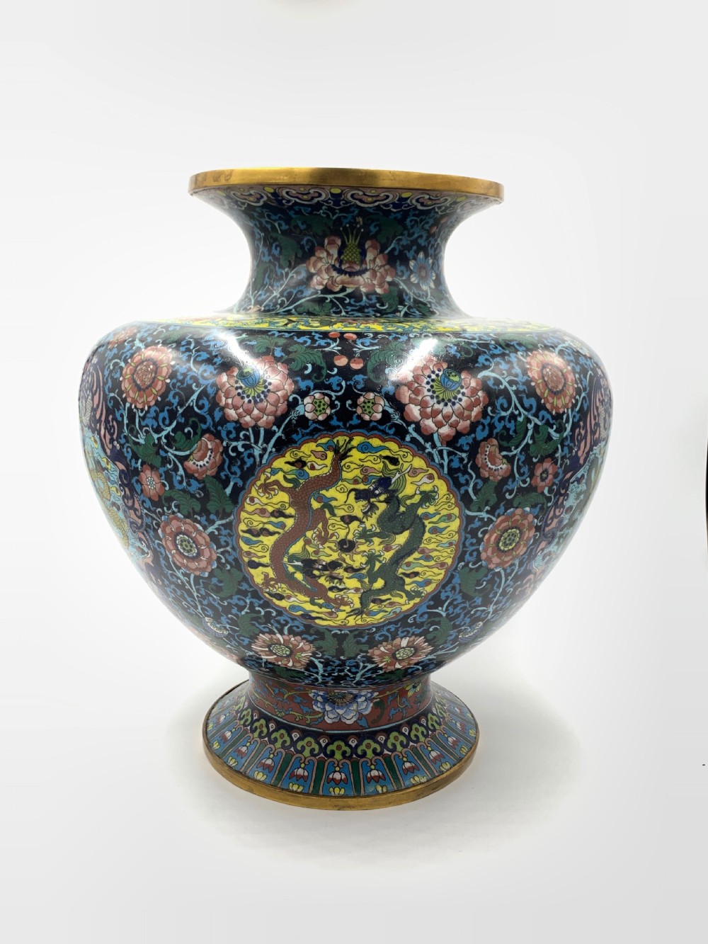 A bulbous 19th-century Chinese cloisonne enamel vase with a flared neck, featuring circular yellow dragon medallions surrounded by dense floral scrollwork on a dark blue ground. View III