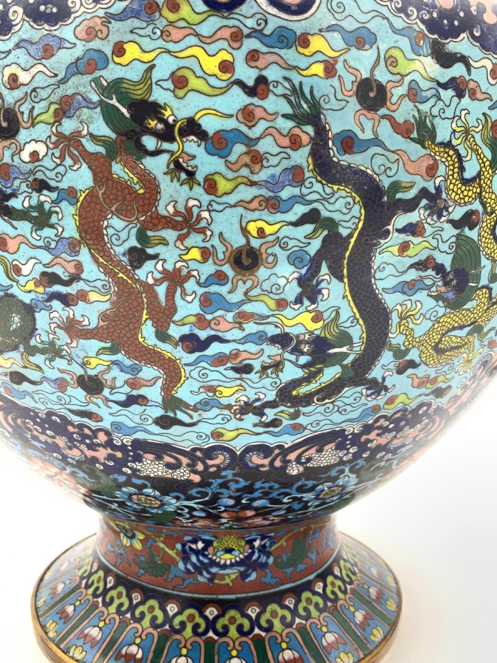A bulbous 19th-century Chinese cloisonne enamel vase with a flared neck, featuring circular yellow dragon medallions surrounded by dense floral scrollwork on a dark blue ground. View VI