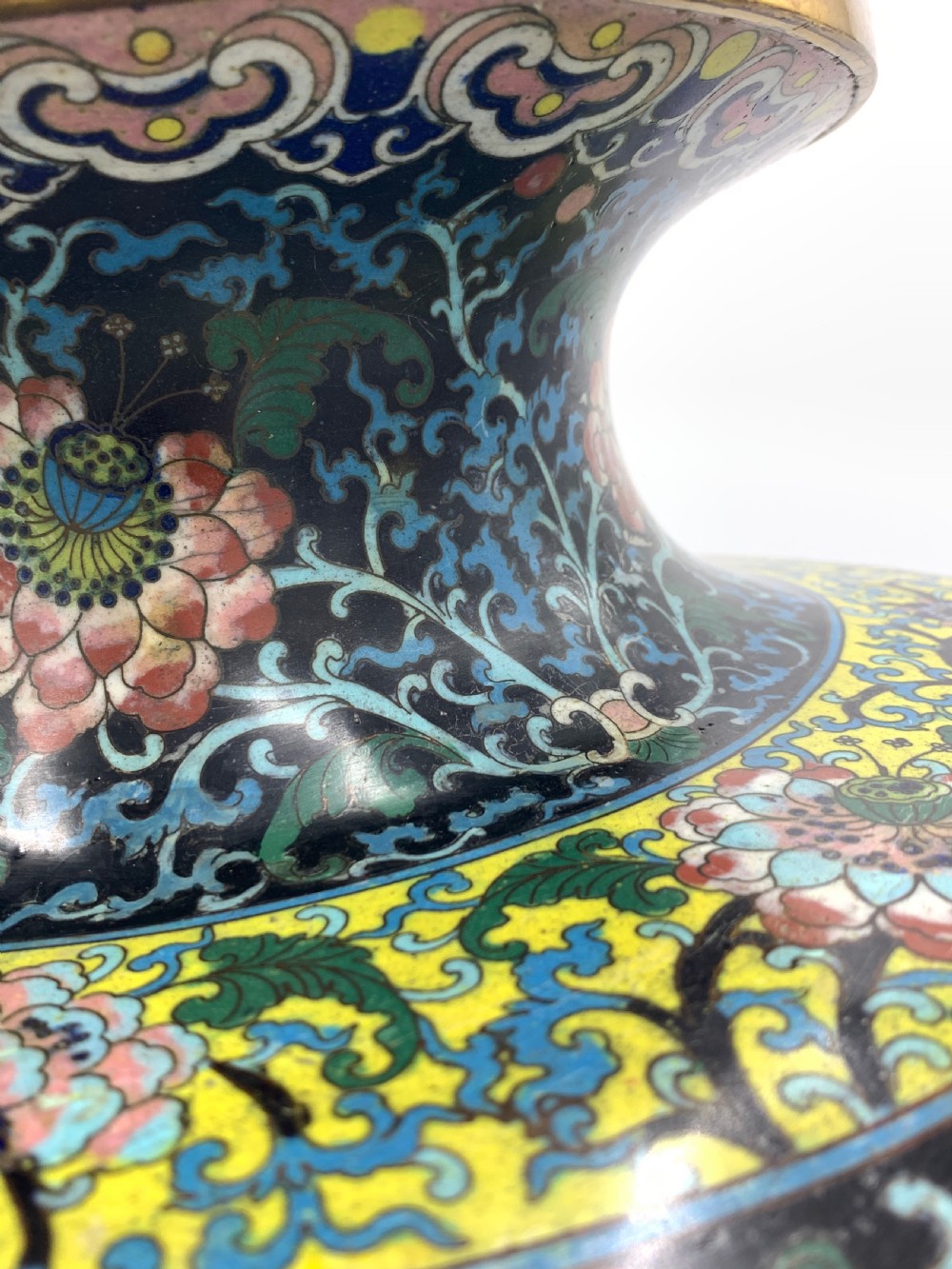 A bulbous 19th-century Chinese cloisonne enamel vase with a flared neck, featuring circular yellow dragon medallions surrounded by dense floral scrollwork on a dark blue ground. View VIII