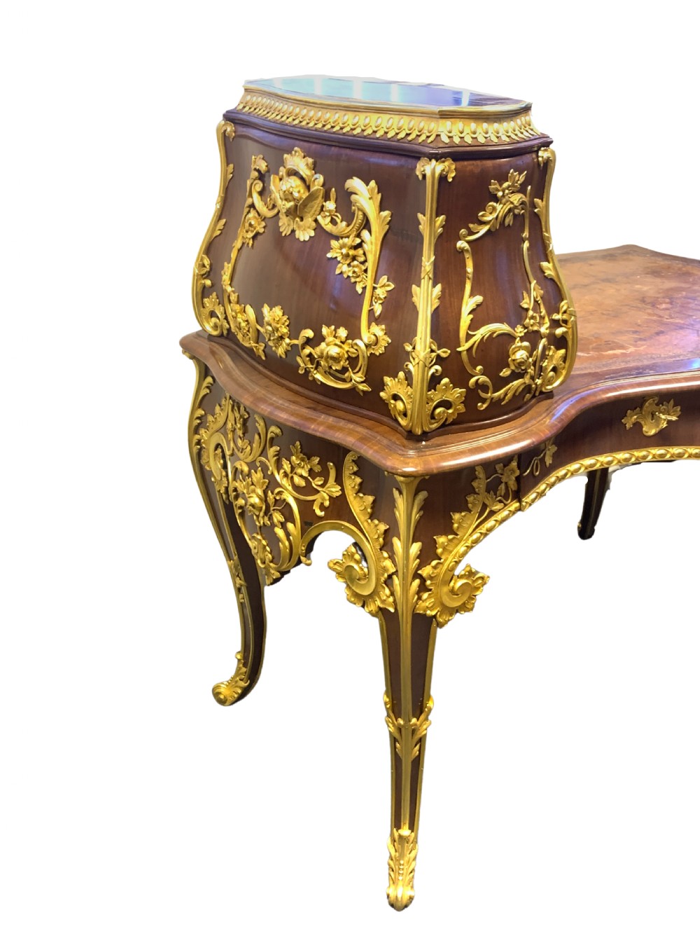 A 19th-century dark wood writing desk featuring elaborate gilt-bronze floral ormolu mounts, cabriole legs, and an asymmetrical raised side superstructure. View VI