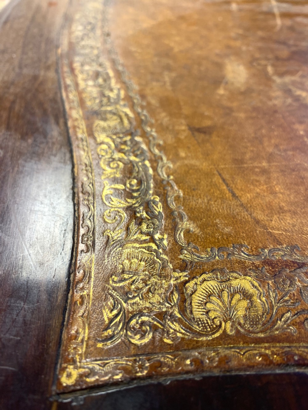 A 19th-century dark wood writing desk featuring elaborate gilt-bronze floral ormolu mounts, cabriole legs, and an asymmetrical raised side superstructure. View VII