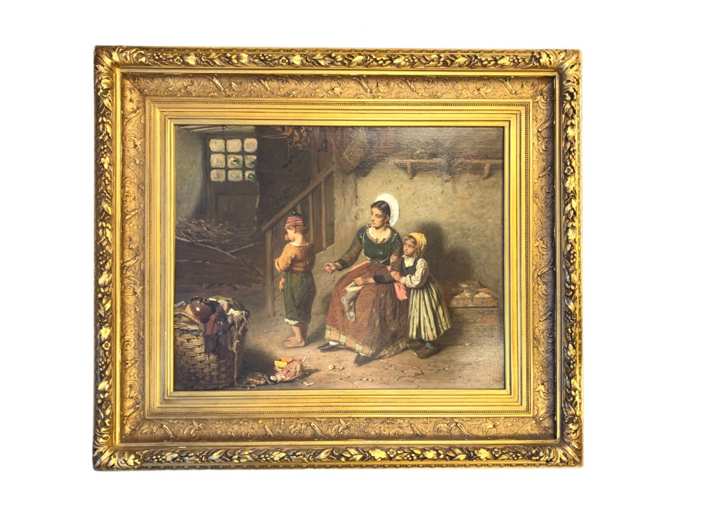 An antique oil painting depicting a mother and two children in a rustic interior, enclosed within an ornate gilded frame.