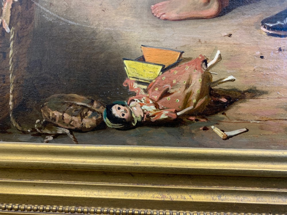 An antique oil painting depicting a mother and two children in a rustic interior, enclosed within an ornate gilded frame. View X