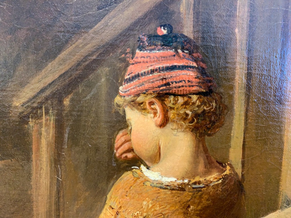 An antique oil painting depicting a mother and two children in a rustic interior, enclosed within an ornate gilded frame. View XII